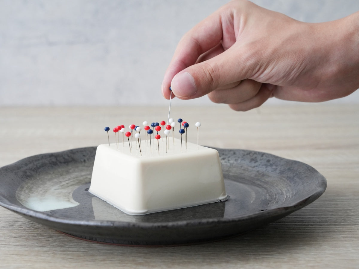 poking needles into tofu