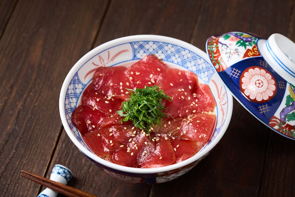 donburi bowl filled with rice and raw tuna slices